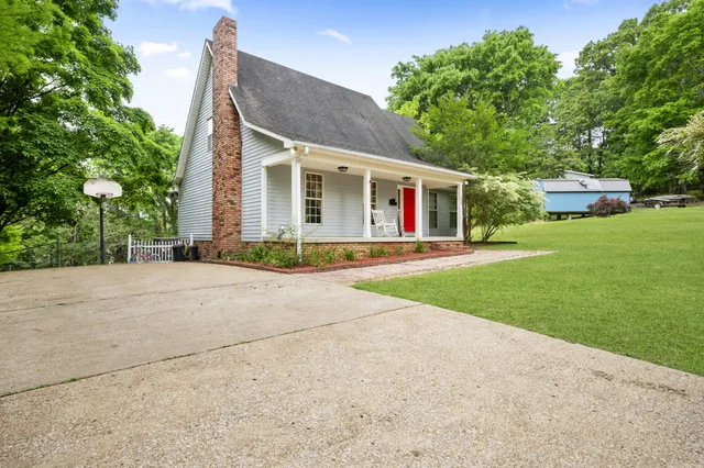 a front view of house with yard and green space