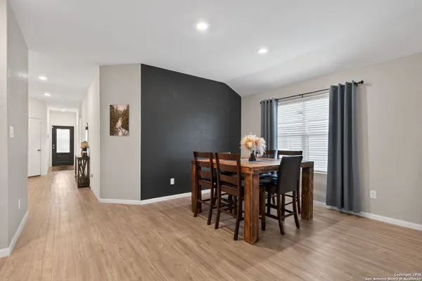 a view of a dining room with furniture and wooden floor