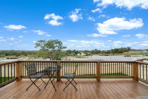 a view of a balcony with wooden floor and city view