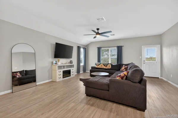 a living room with furniture a fireplace and a flat screen tv