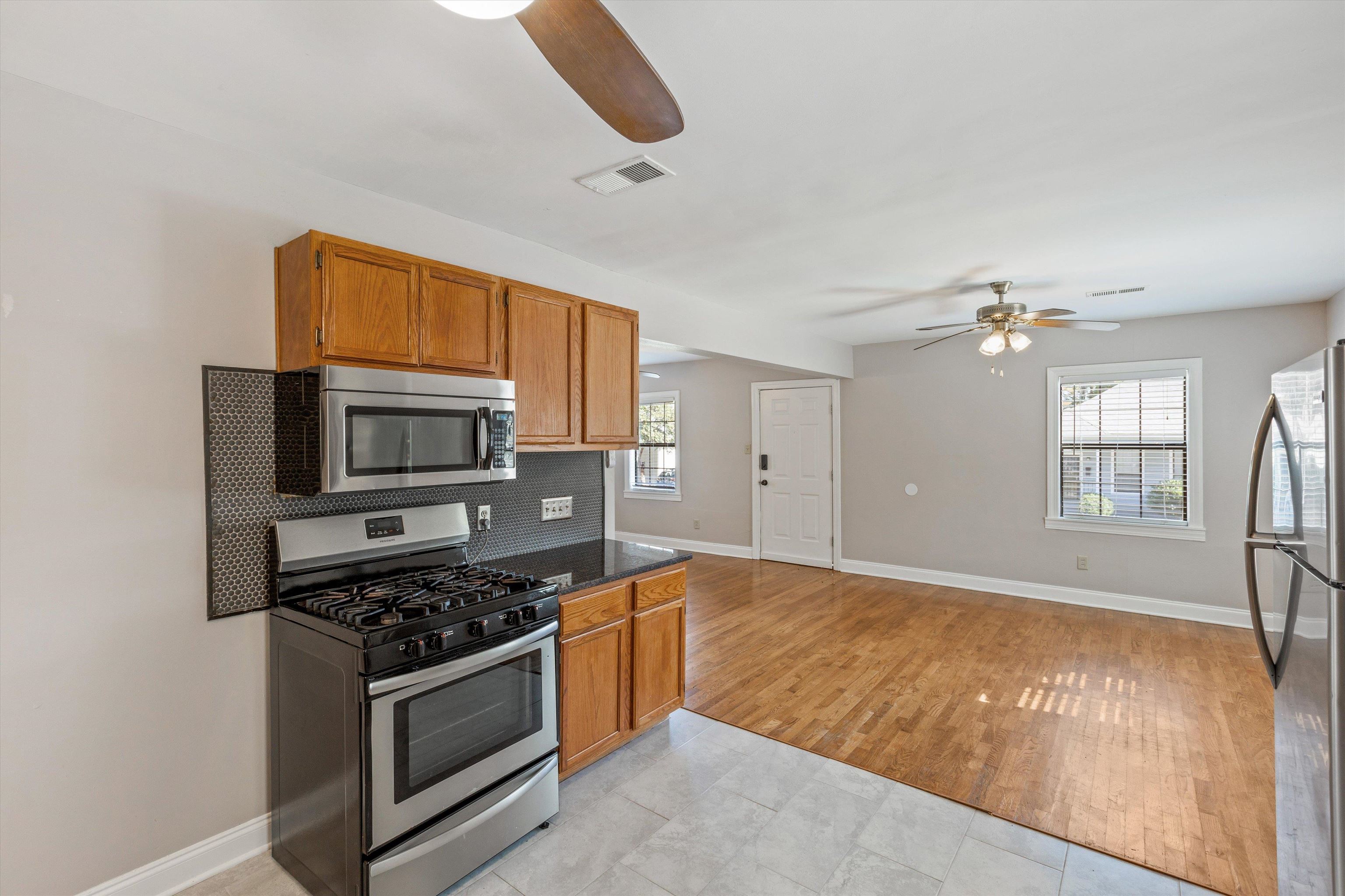 1011 Philadelphia Street Memphis, TN 38104 - Photo 13 of 26 a kitchen with stainless steel appliances granite countertop a stove top oven a sink dishwasher and a microwave oven with cabinets