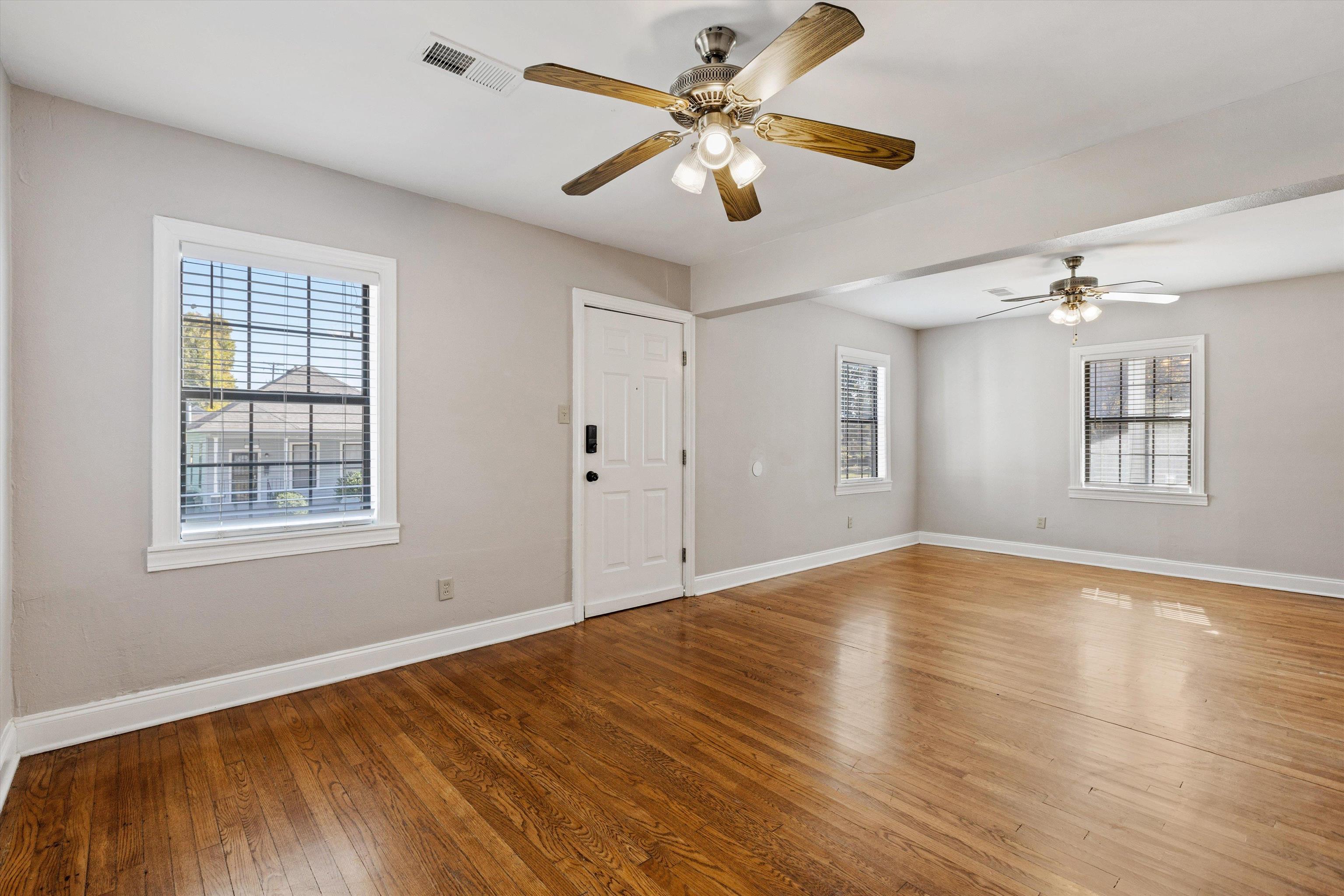 1011 Philadelphia Street Memphis, TN 38104 - Photo 6 of 26 a view of an empty room with wooden floor and a window