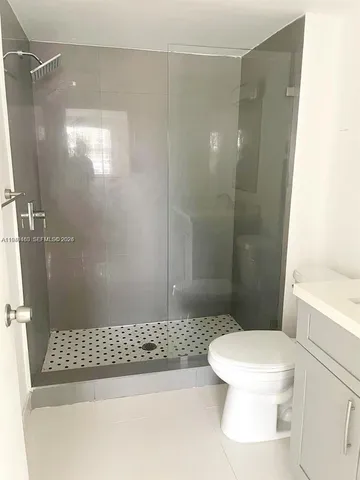 a bathroom with a shower and a toilet
