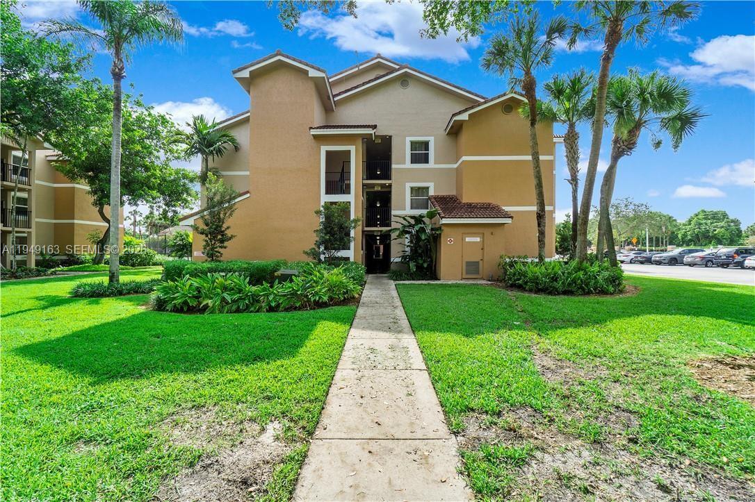 8821 Wiles Road, Unit 101 Coral Springs, FL 33067 - Photo 16 of 16 a front view of house with yard and green space