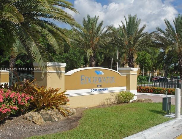 8821 Wiles Road, Unit 101 Coral Springs, FL 33067 - Photo 2 of 16 a front view of a house with garden