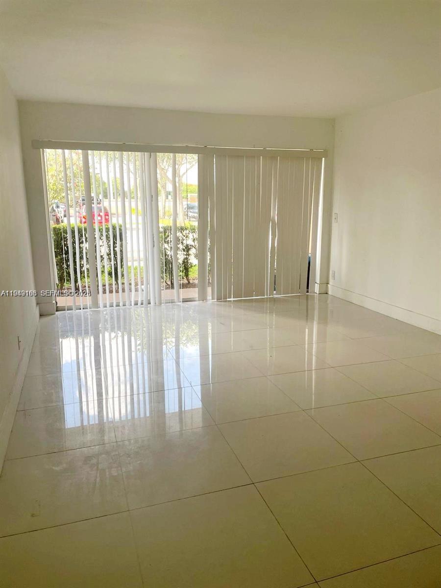 8821 Wiles Road, Unit 101 Coral Springs, FL 33067 - Photo 10 of 16 a view of an empty room with a window