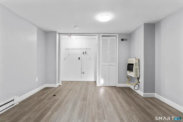 a view of empty room with wooden floor