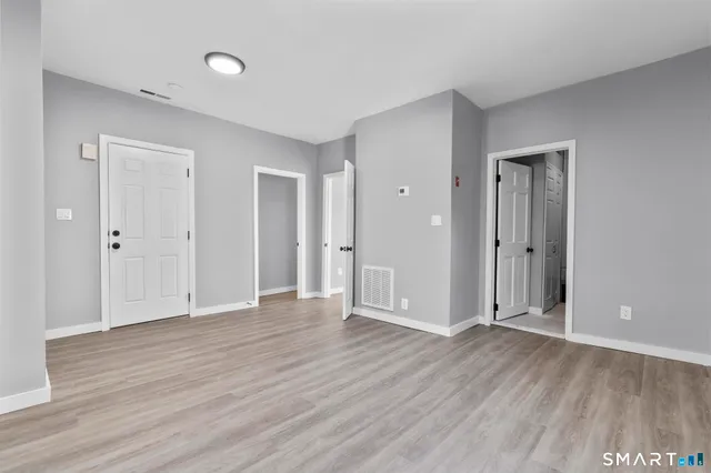 a living room with furniture flowerpot and wooden floor