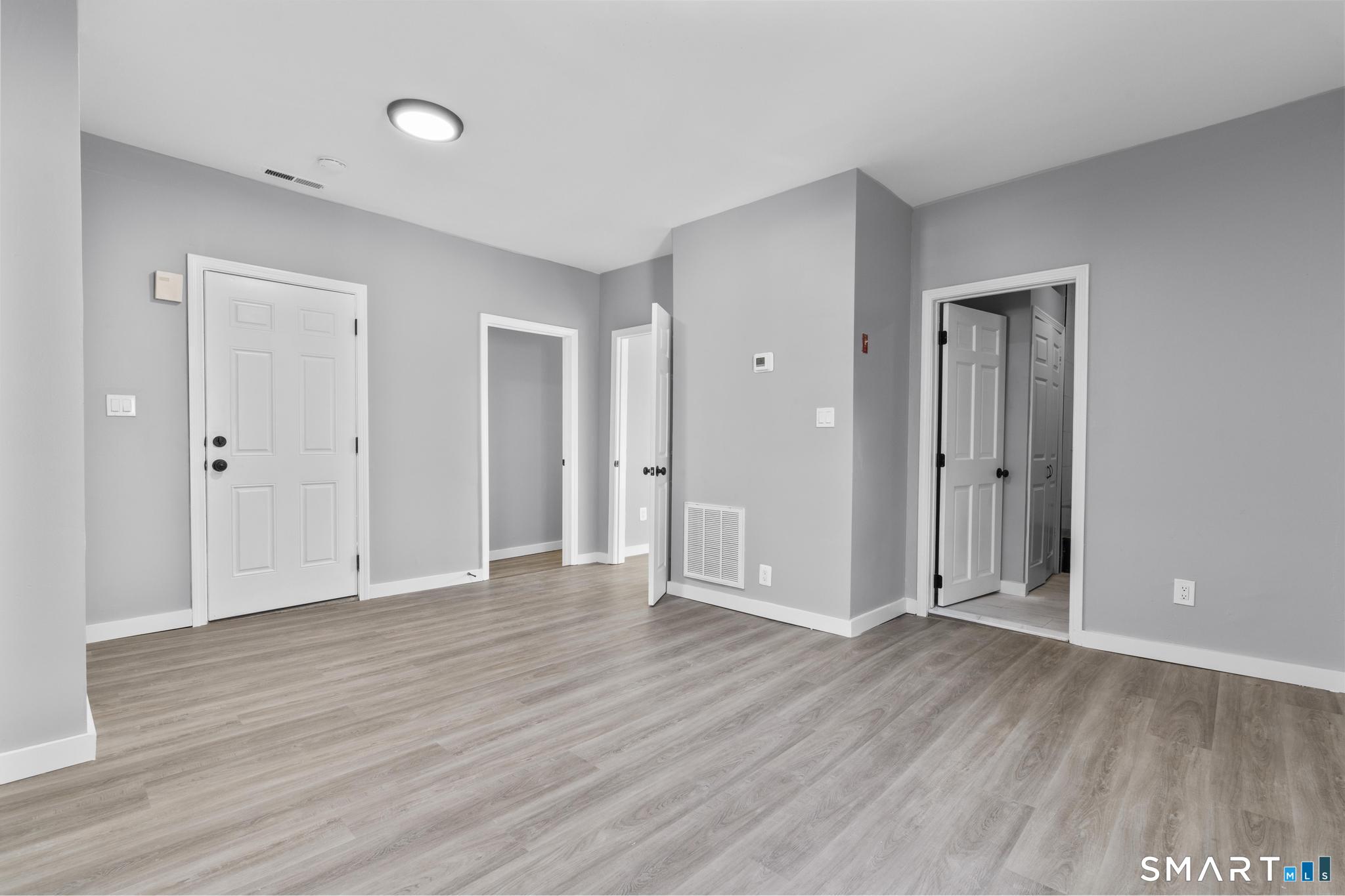 257 North State Street Ansonia, CT 06401 - Photo 19 of 39 a view of an empty room with wooden floor and closet