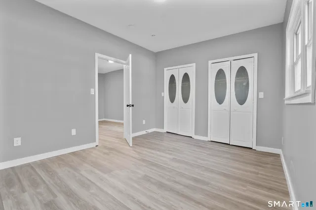 a view of room with window and hardwood floor