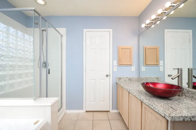 a spacious bathroom with a granite countertop sink a toilet and shower