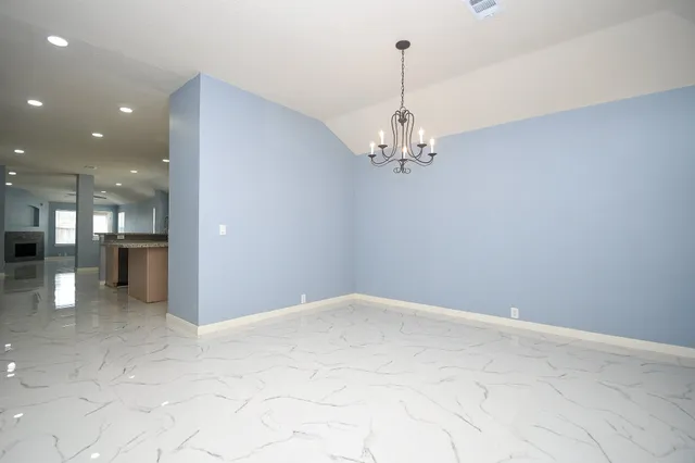 a view of a chandelier in big room and chandelier