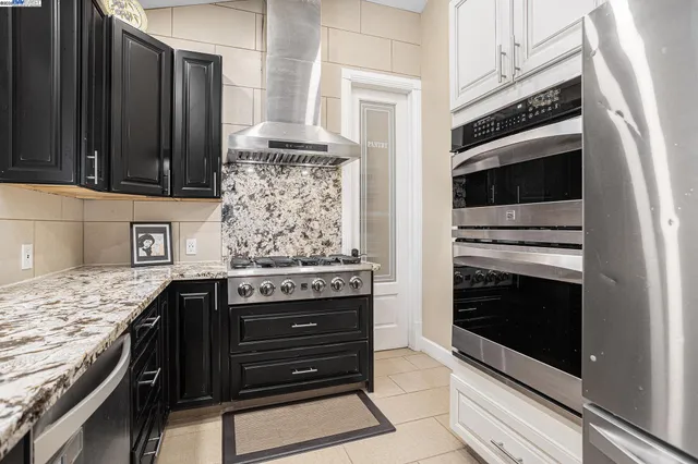 a kitchen with granite countertop a stove and a microwave oven