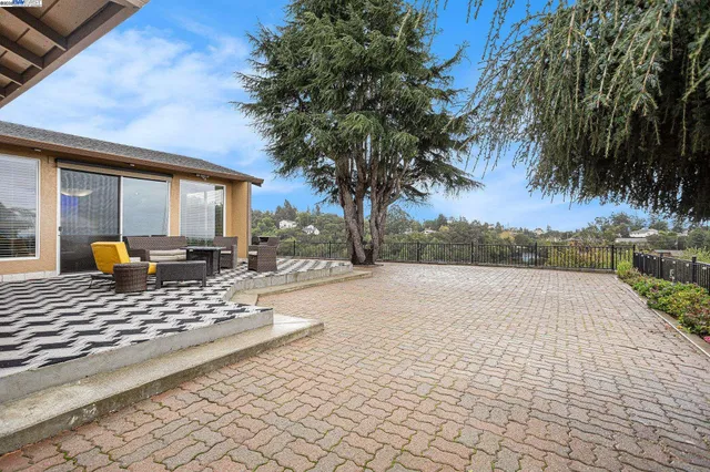 a view of a backyard with sitting area