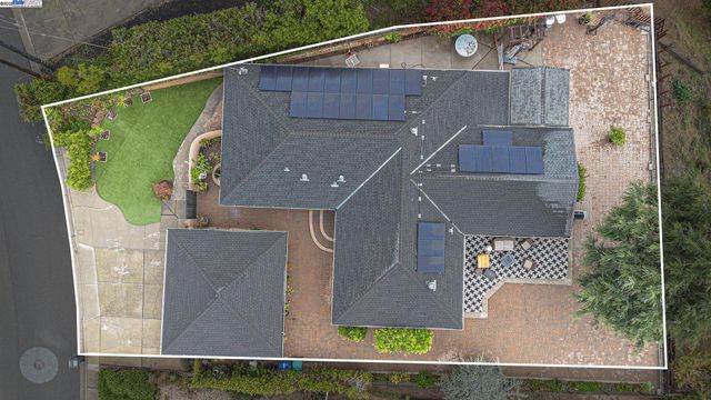 an aerial view of a house with a yard
