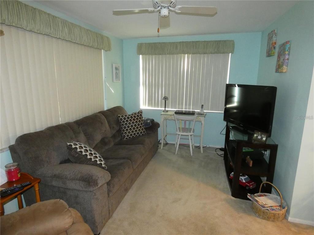4392 Craftsbury Drive New Port Richey, FL 34652 - Photo 6 of 41 a living room with furniture and a flat screen tv