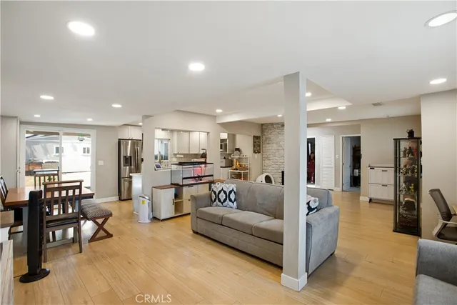 a living room with furniture and kitchen view