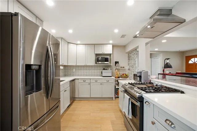 a kitchen with a sink stove and refrigerator