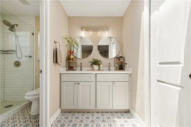 a bathroom with a sink a potted plant and a mirror