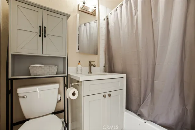 a yellow house with trees in front of it