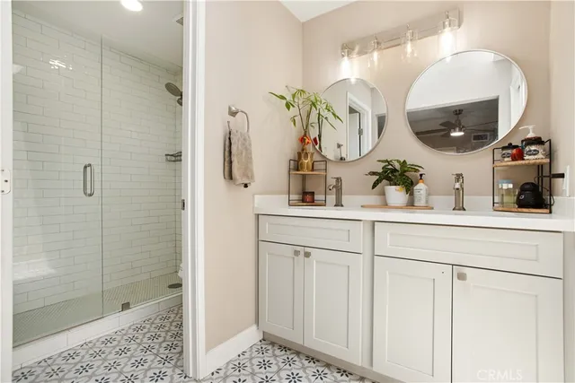 a bathroom with a sink a potted plant and a mirror