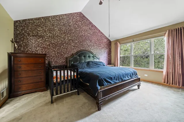 a spacious bedroom with a bed and a window