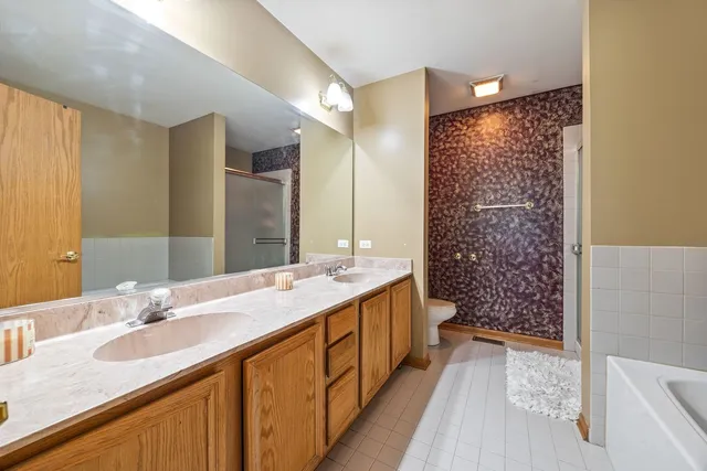 a bathroom with a double vanity sink mirror double and shower