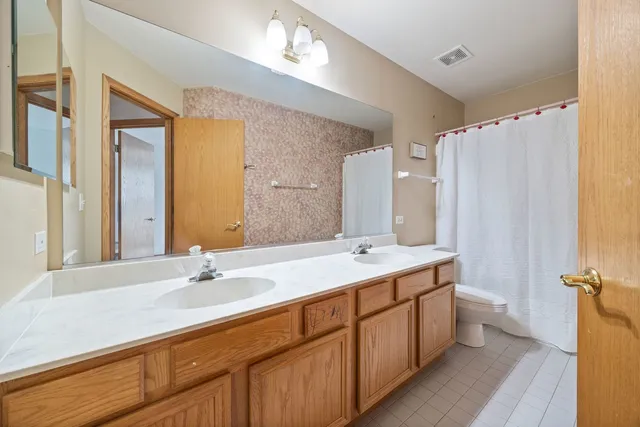 a bathroom with a double vanity sink mirror and double