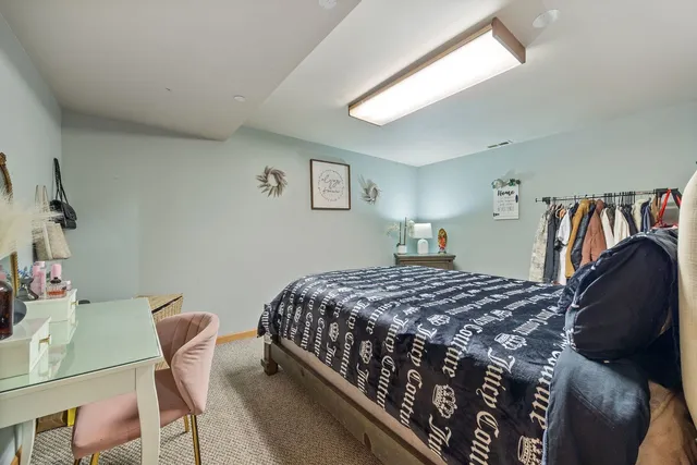 a bedroom with a bed and a chair