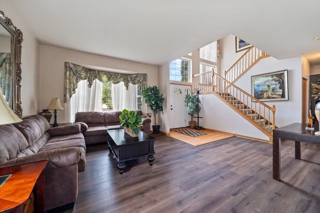 a living room with furniture and wooden floor