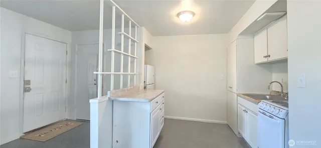 a hallway with sink a washer and dryer