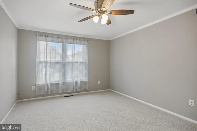 an empty room with a empty space and a ceiling fan