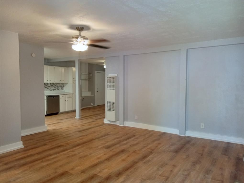 4500 Avenue D, Unit B Austin, TX 78751 - Photo 2 of 16 Unfurnished living room with ceiling fan, a heating unit, and light wood-style flooring