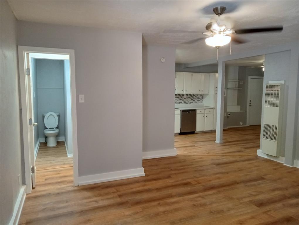 4500 Avenue D, Unit B Austin, TX 78751 - Photo 3 of 16 Unfurnished living room featuring light wood-type flooring, a heating unit, and a ceiling fan