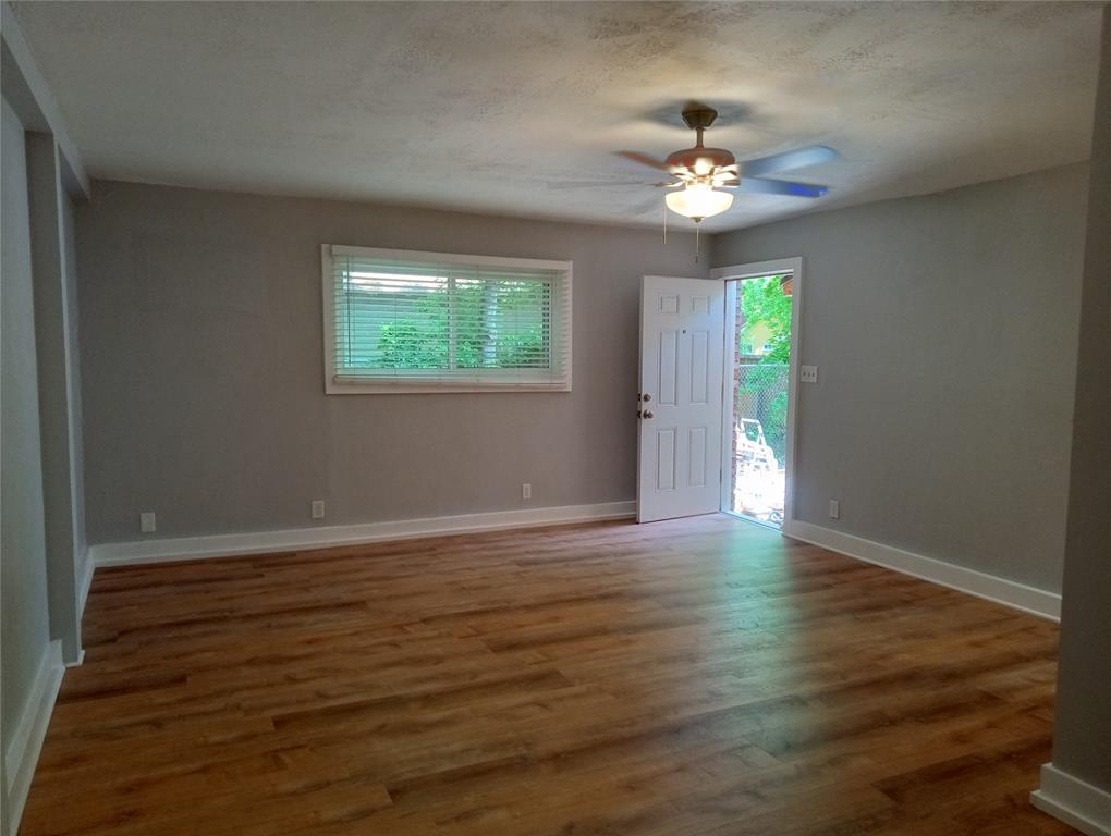 4500 Avenue D, Unit B Austin, TX 78751 - Photo 4 of 16 Unfurnished room with wood finished floors, a ceiling fan, and a textured ceiling