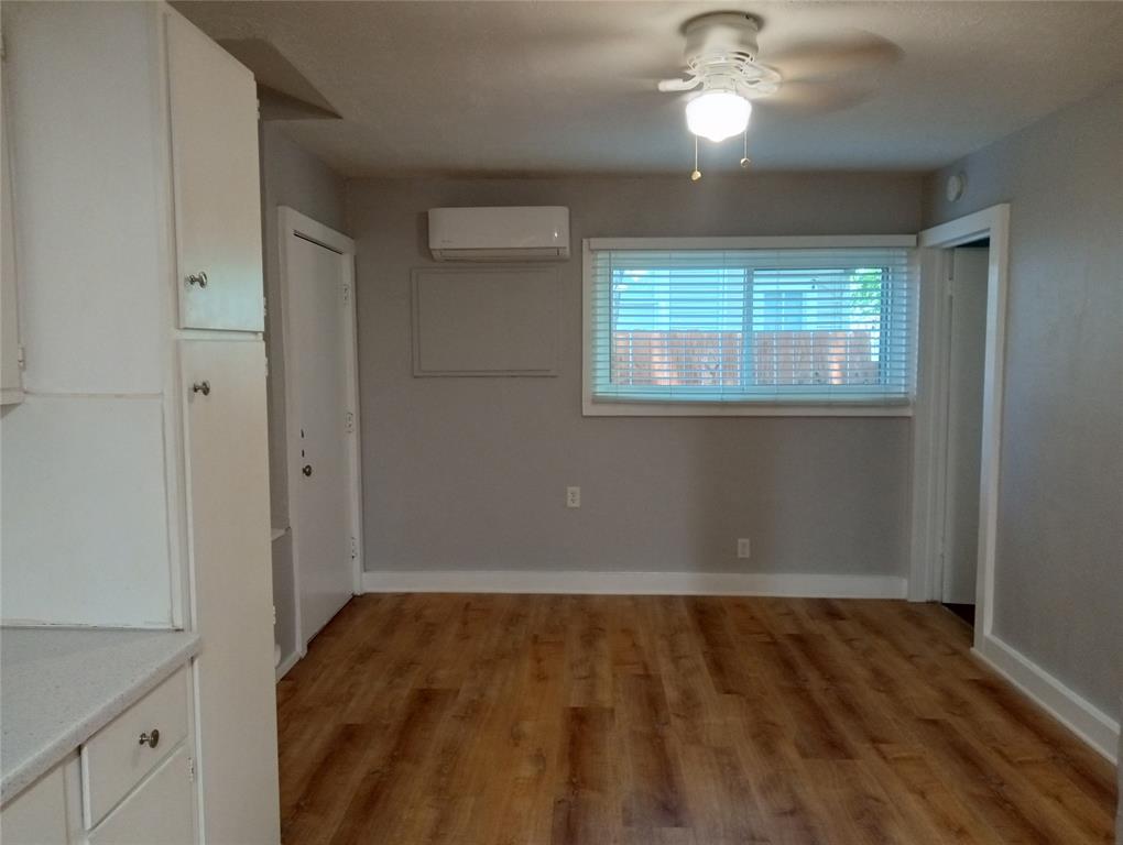 4500 Avenue D, Unit B Austin, TX 78751 - Photo 9 of 16 Unfurnished bedroom with light wood-style floors, a mini split for heating / cooling, and a ceiling fan