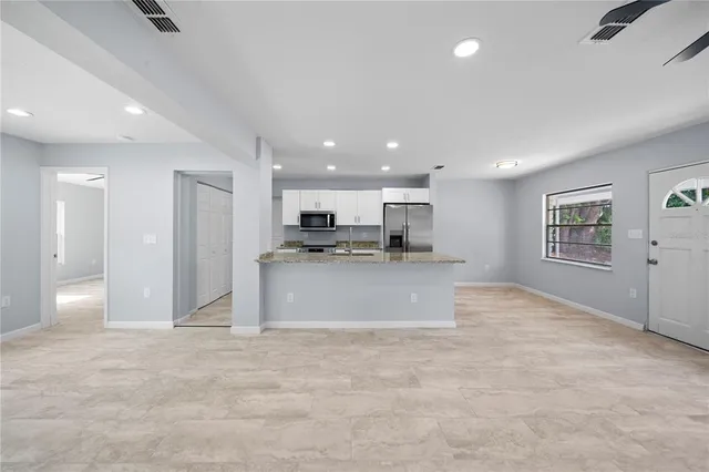 a view of kitchen cabinet and refrigerator