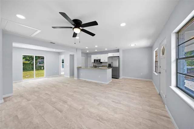 an empty room with yard and large window