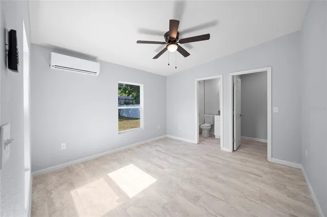 a bathroom with a granite countertop toilet a sink and mirror