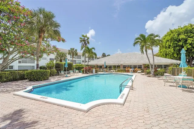 a view of swimming pool with outdoor seating and a garden