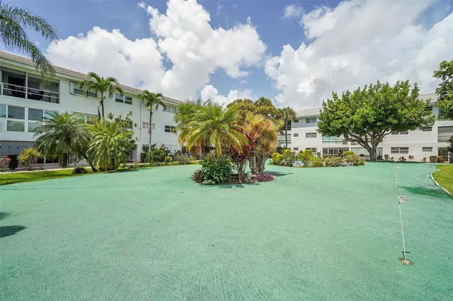 a view of a hallway to a livingroom with furniture and stairs
