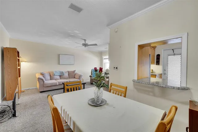 a dining room with furniture and wooden floor
