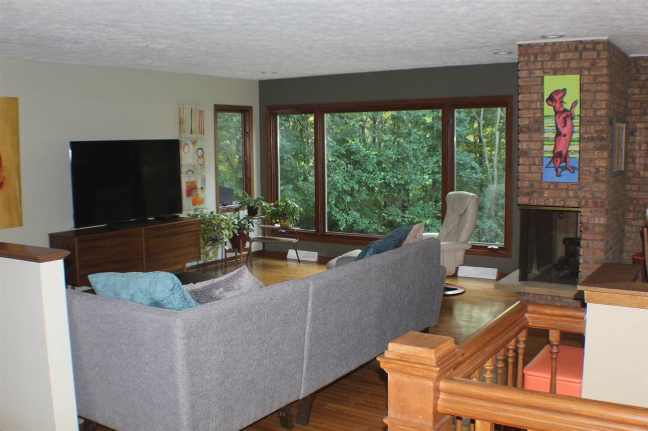 840 Spring Ridge Court Belvidere, IL 61008 - Photo 7 of 25 a living room with fireplace furniture and a flat screen tv