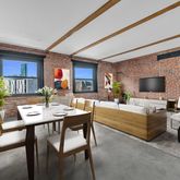 a view of a livingroom with furniture and a flat screen tv