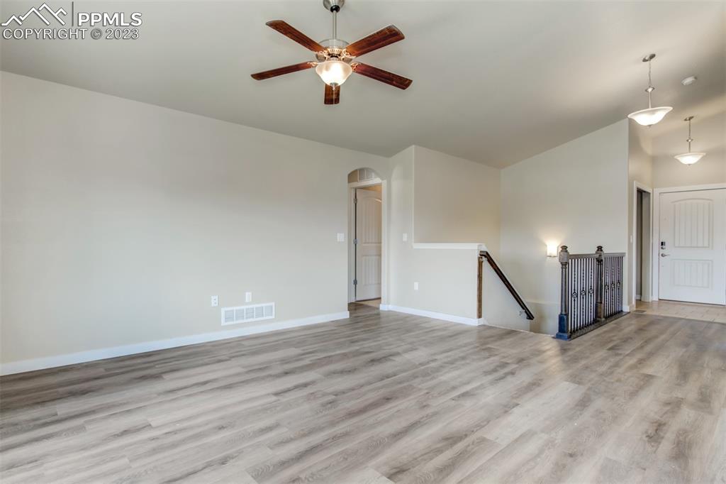 10034 Intrepid Way Colorado Springs, CO 80925 - Photo 13 of 31 a view of an empty room with window and a ceiling fan