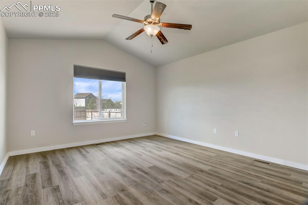 10034 Intrepid Way Colorado Springs, CO 80925 - Photo 14 of 31 wooden floor in an empty room with a window