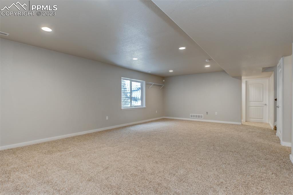 10034 Intrepid Way Colorado Springs, CO 80925 - Photo 21 of 31 a view of an empty room with a window