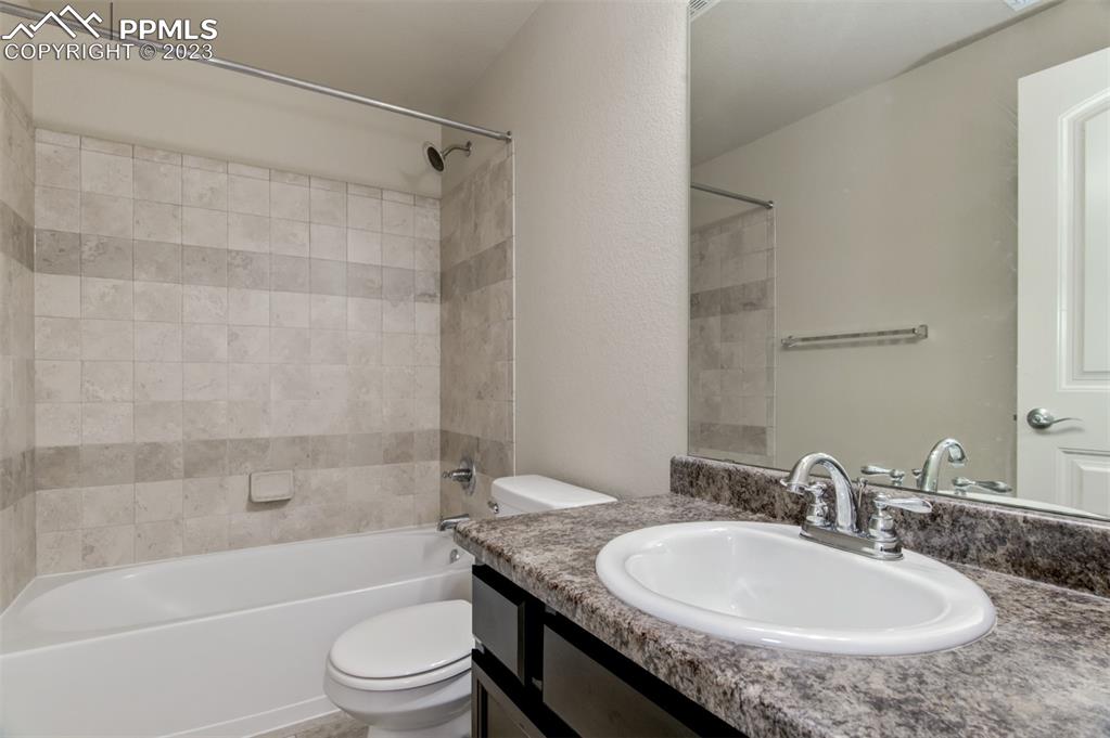 10034 Intrepid Way Colorado Springs, CO 80925 - Photo 24 of 31 a bathroom with a granite countertop sink toilet and shower