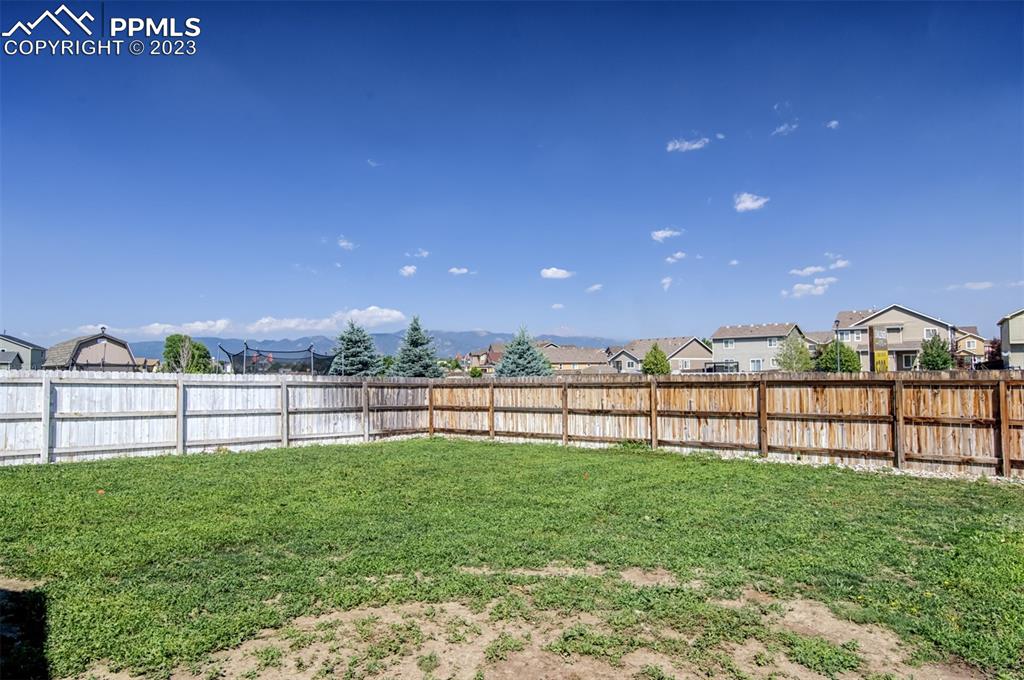 10034 Intrepid Way Colorado Springs, CO 80925 - Photo 28 of 31 a view of outdoor space with seating area and green space