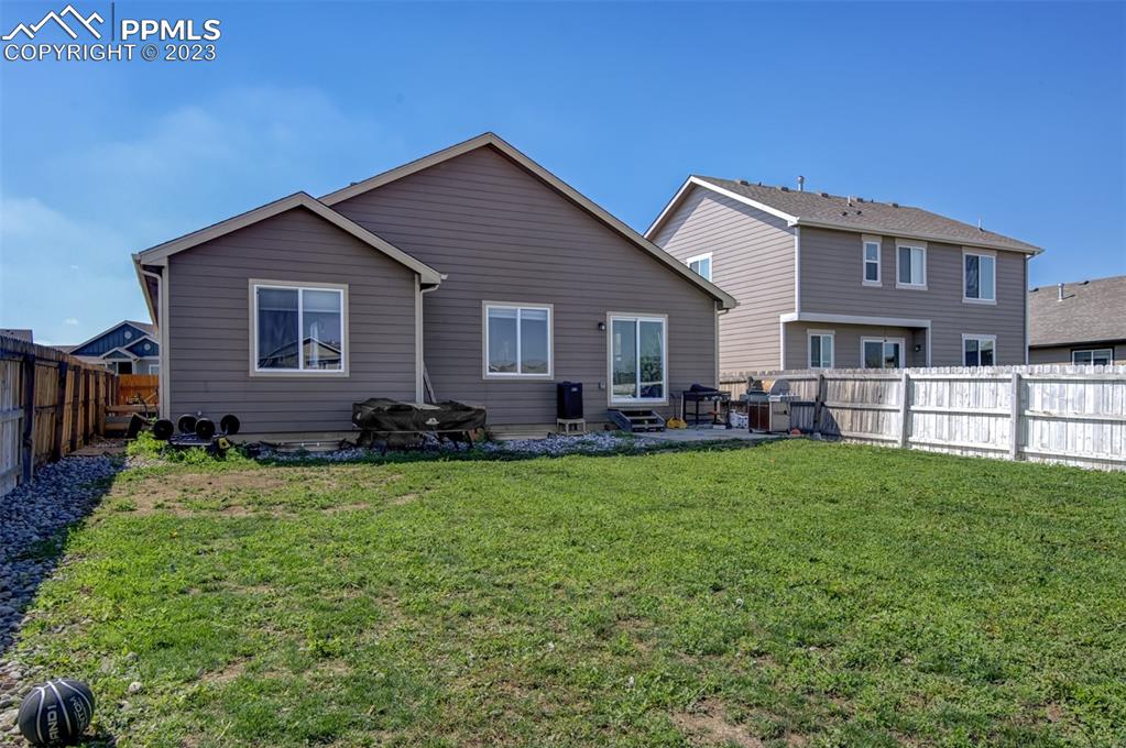 10034 Intrepid Way Colorado Springs, CO 80925 - Photo 29 of 31 a front view of house with yard and green space